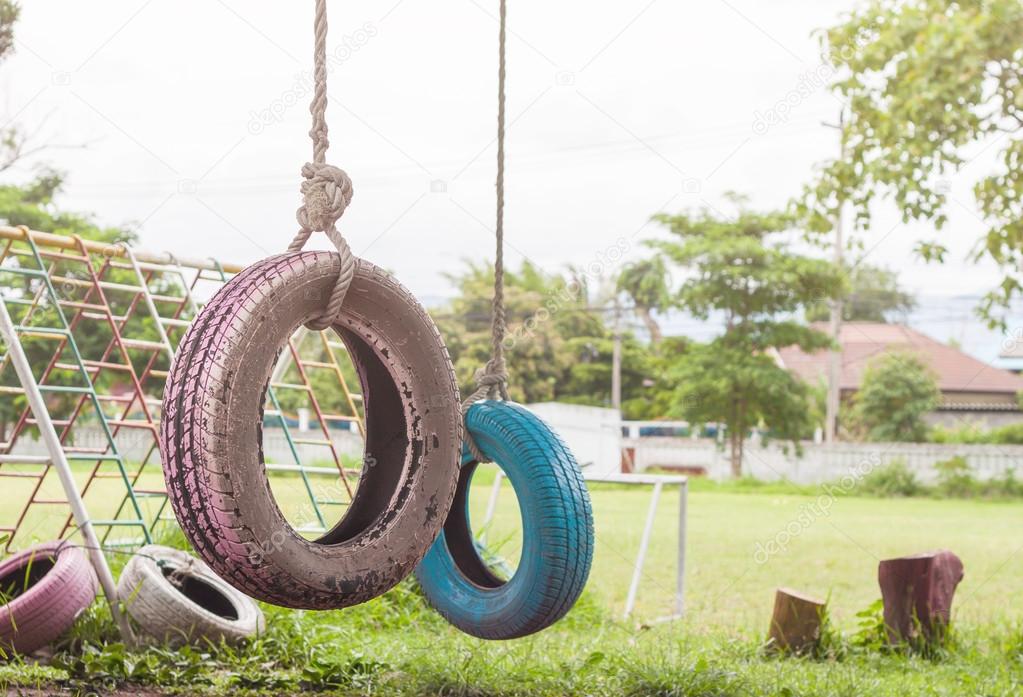 Tire Swing Hanging From A Tree In The Playground Stock
