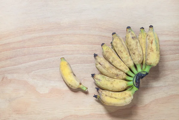 Organic cultivated banana on the wooden background — Stock Photo, Image