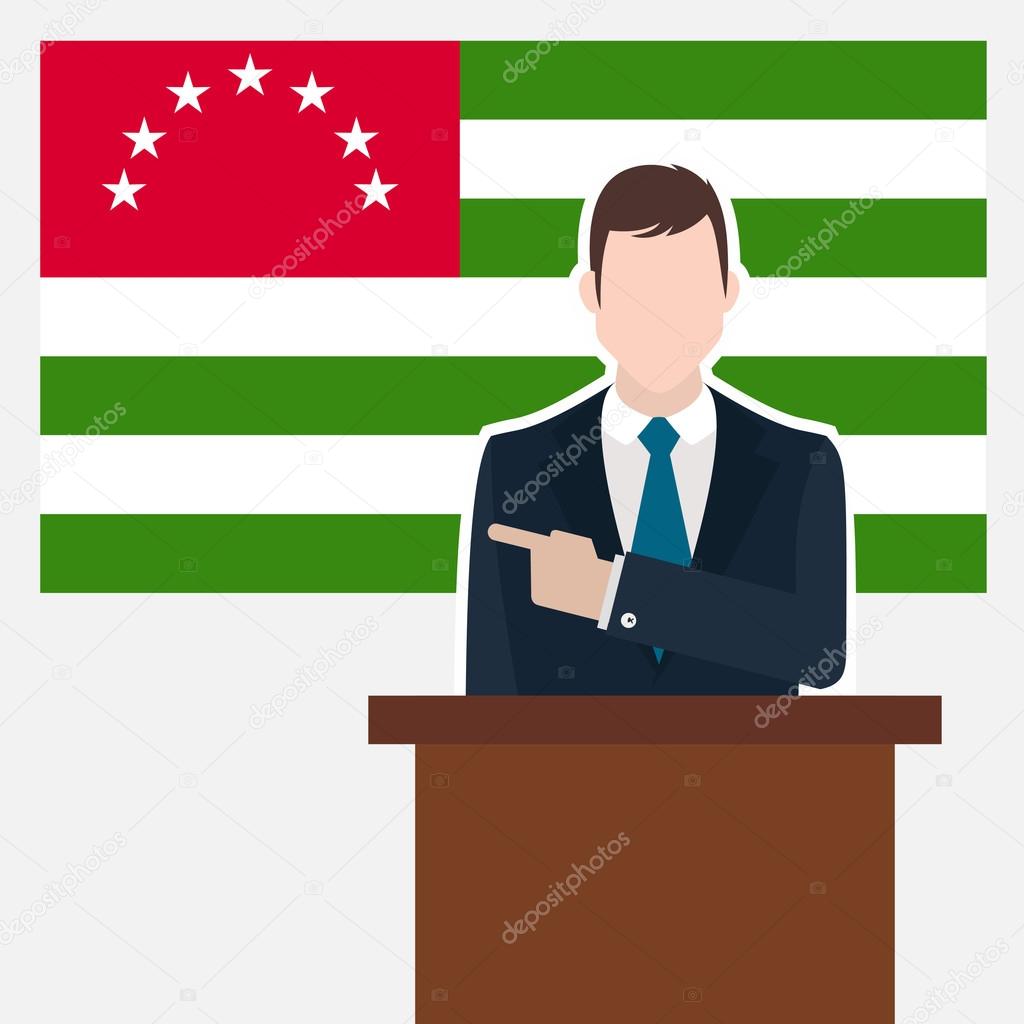 Man in suit standing at rostrum 