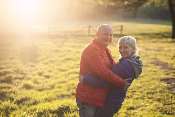 Happy seniors couple embrace and smile; — Stock Photo, Image