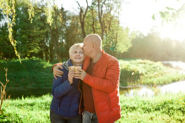 Happy seniors couple embrace and smile; — Stock Photo, Image