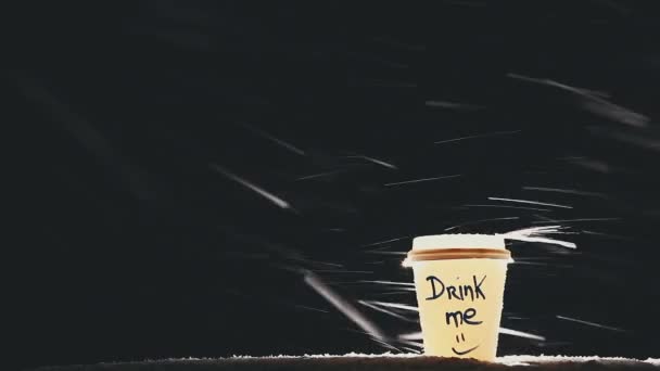 Srandovní papírové sklo s teplým nápojem nebo kávou ve zasněžené zimní noci venkovní — Stock video