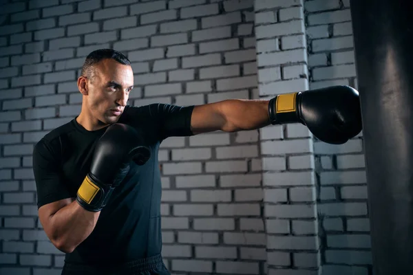 Sportovní muž boxer trénink s boxovací pytel nebo cvičení v tělocvičně — Stock fotografie