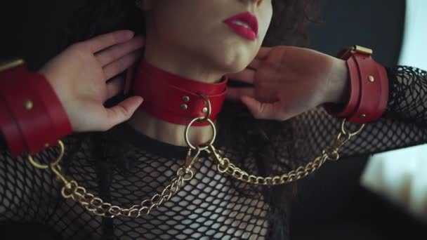 Sensual female with red lips, leather bondage collar choker and handcuff — Stock Video