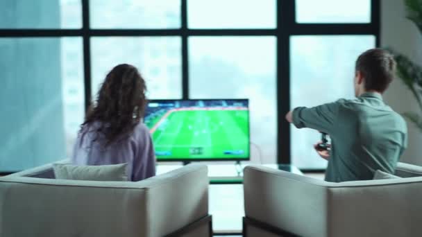 Щаслива пара грає в відеогру з контролером на ігровій консолі вдома — стокове відео