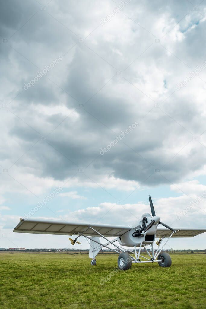 remote controlled agriculture spaying air plane in field at sunset, no people