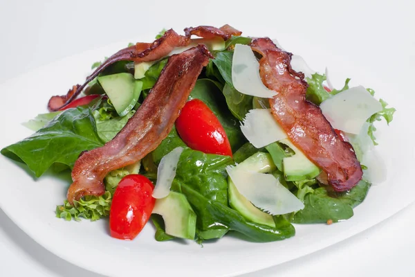 Tasty green fresh salad with bacon isolated — Stock Photo, Image