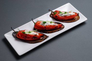 Siyah arka planda süzme peynirle doldurulmuş Bulgar biberlerinin yakın çekimi