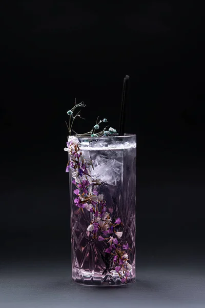 Bebida de cocktail violeta fizz de luxo com decoração de flores em fundo preto — Fotografia de Stock