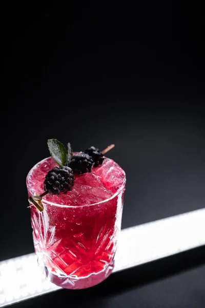 Closeup of alcohol blueberry special cocktail with blackberry in wineglass — Stock Photo, Image