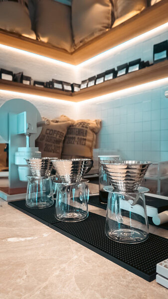 craft coffee bar with pour over brewing equipment, specialty cafe manual drip station glass carafes. High quality photo