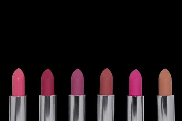 Assorted lipsticks on black background — Stock Photo, Image