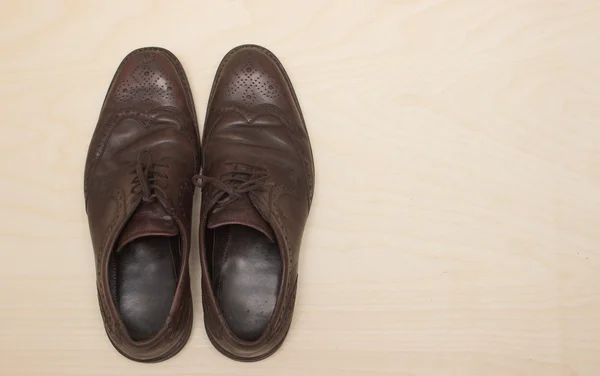 Zapatos masculinos de cuero marrón sobre fondo de madera, plano — Foto de Stock