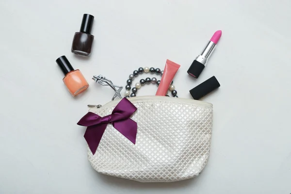 Sac de maquillage avec cosmétiques et brosses sur fond en bois — Photo