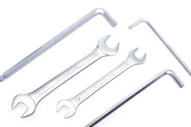 Different sized chrome wrenches isolated on white, top view 