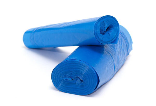 Roll of blue plastic garbage bags isolated on white
