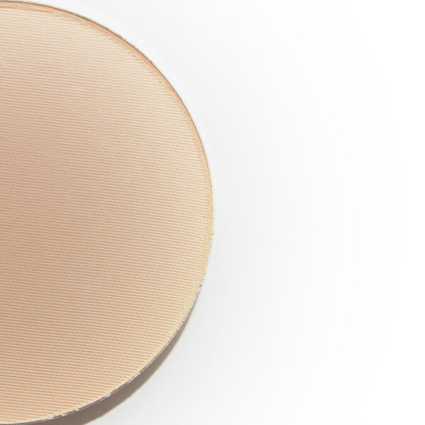 Half of natural beige pressed powder isolated