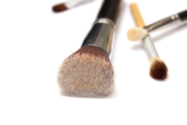 Assorted make up brushes on white background