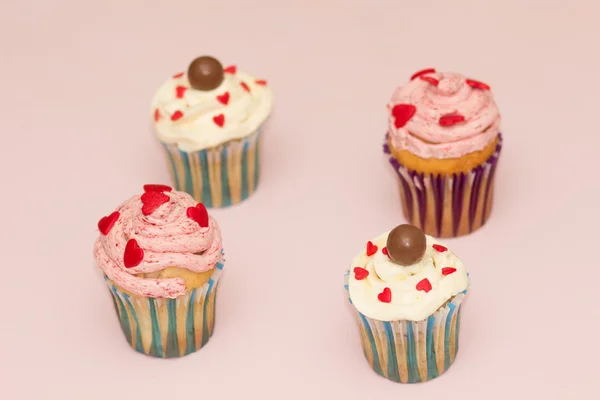 Cupcakes crema del desierto rosa y blanco sobre fondo rosa — Foto de Stock