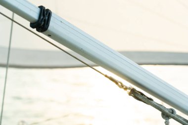 Yattaki beyaz yelkenliyi güneş ışığı yansıması ile kapatın.