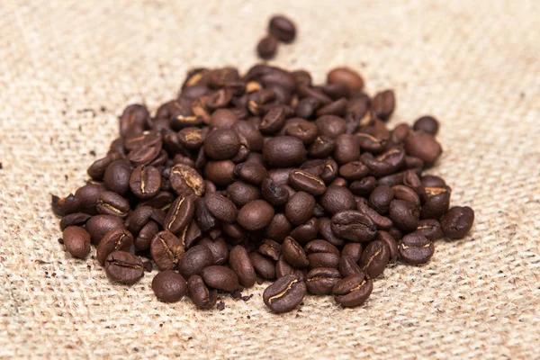 Coffee beans on burlap sack. Food and drink coffee background.
