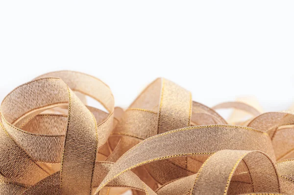 Gold ribbons on a white background. — Stock Photo, Image