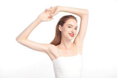 Güzel genç kadın, beyaz bir arka plan, pürüzsüz bir koltuk altı temizliği ve korunma kavramına karşı ellerini kaldırır ve temiz ve hijyenik bir şekilde ellerini kaldırır.