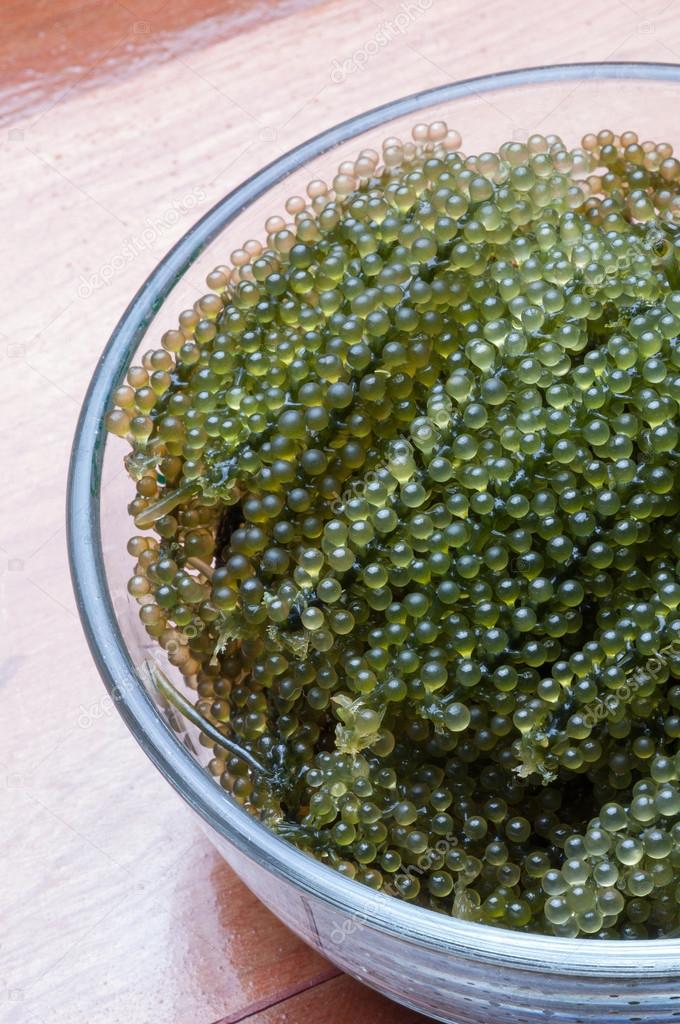 Sea grapes in heart dish on the table