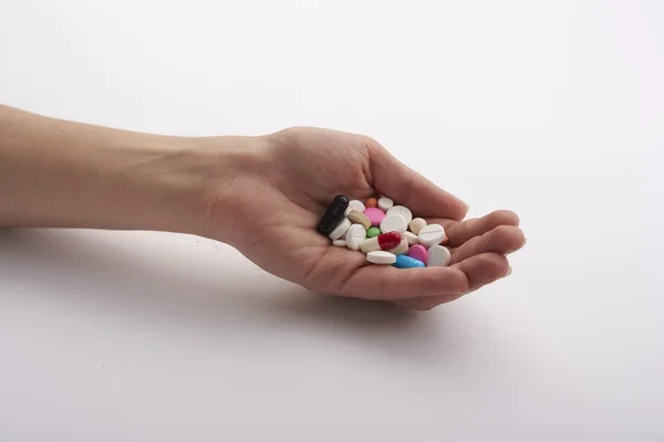Um punhado de comprimidos na mão — Fotografia de Stock