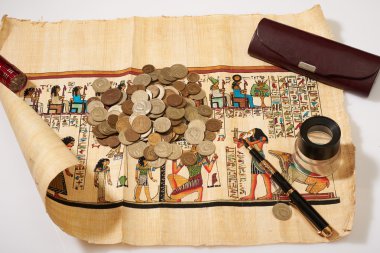 ancient Egyptian papyrus and many coins it clipart
