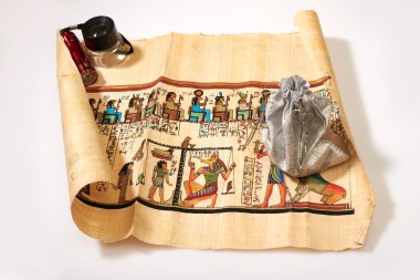 Egyptian scroll, lights and a bag of money clipart