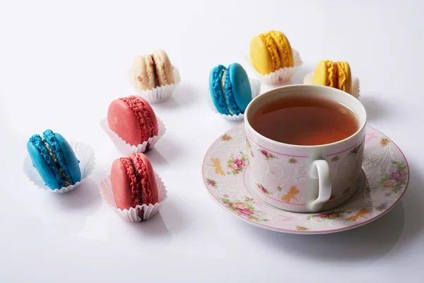 Multicolored macaroon and tea on a white background — Stock Photo, Image