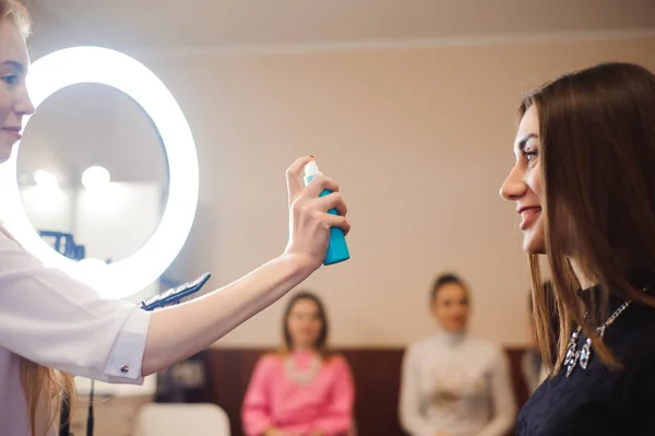 School of makeup. Students of a professional make-up artist in class.