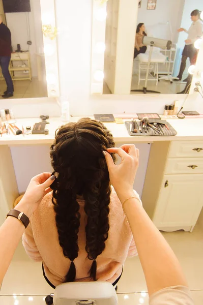 Beautiful woman getting haircut by hairdresser in the beauty salon.