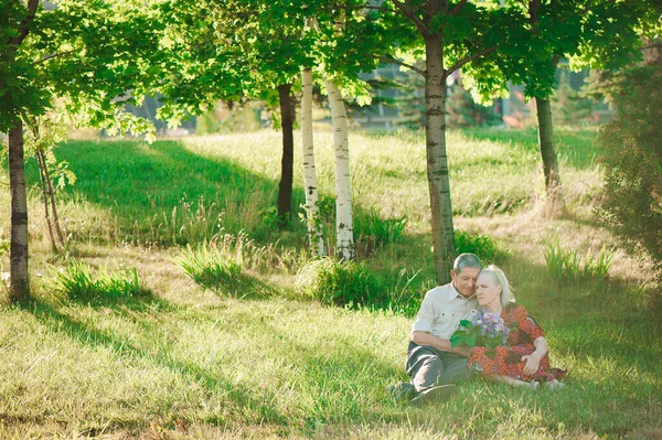 Happy and very old people sitting in the park.