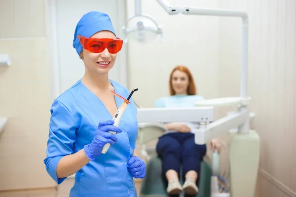 Young woman having medical checkup in the dentist office by the doctor.