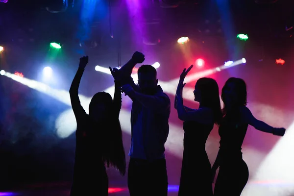 party, holidays, celebration, nightlife and people concept - group of happy friends dancing in a night club