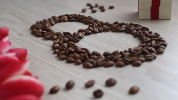 Flowers - tulips, gift, numeral eight of coffee beans on white table. — Stock Video