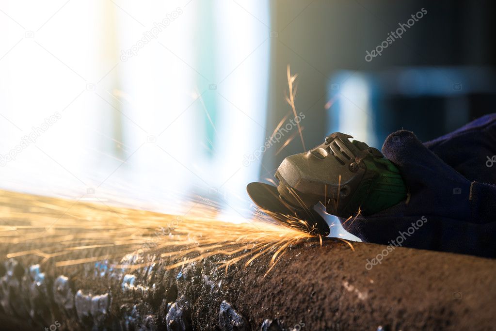 Cropped image of grinding process by electric wheel in heavy industrial