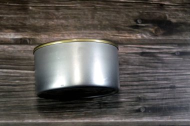 a metal tin can with a pull-tab lid, a common type of packaging for canned food, the cans used to preserve food, such as fish and provide a long shelf life, canned fish tuna, selective focus