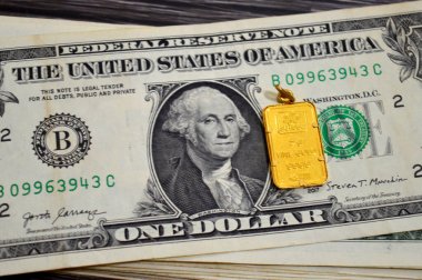 Kahire, Mısır, 29 Ekim 2025: Amerikan doları nakit para banknotları ve PAMP Suisse altın kolyesi, 24K Altın Çubuk 5 gram, saf altın 999.9 gram, yatırım veya tasarruflar için, İsviçre altın rafinerileri