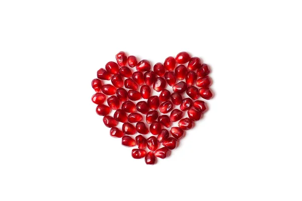 Beyaz zemin üzerine nar taneleri kalbinde.