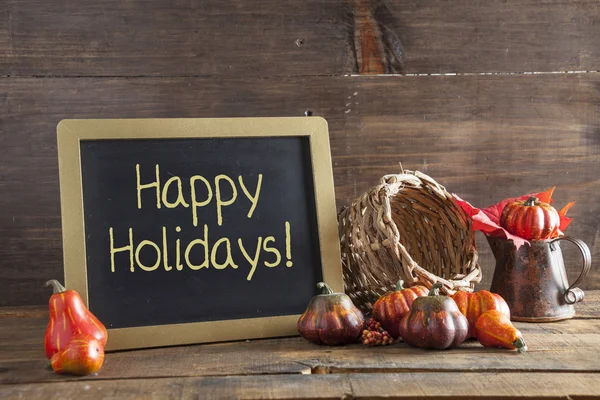 Happy Holidays Written In Yellow Chalk On Black Chalkboard Backg — Stock Photo, Image