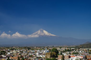 Popocatepetl Volcano Towering over the town of Puebla, Mexico clipart