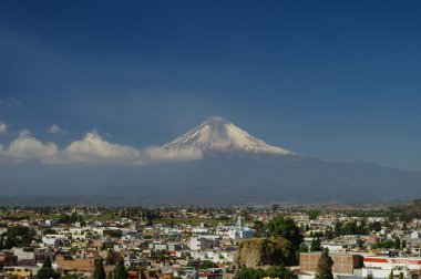 Popocatepetl Volcano Towering over the town of Puebla, Mexico clipart