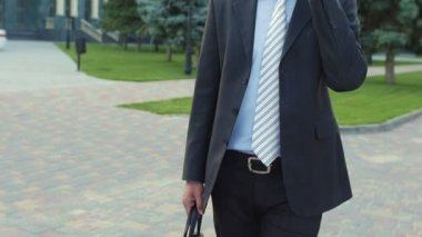 Young successful happy businessman talking on the phone