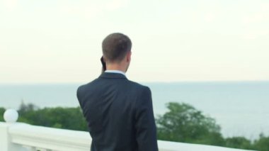 Young successful happy businessman talking on the phone