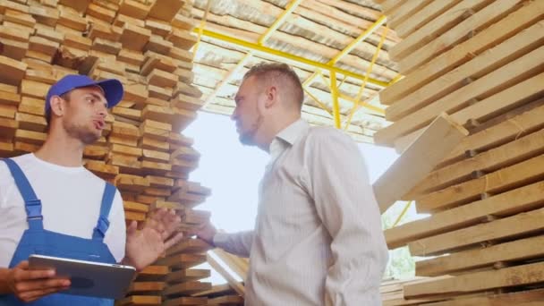 Young warehouse worker timber to communicate with customers — Stock Video