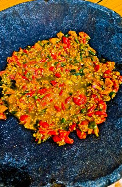 A view of traditional fried chili sauce.Made from chilies, shallots, garlic, tomatoes, and salt, all ground together.