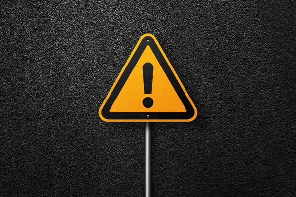 Road sign triangular shape with exclamation mark on a background of asphalt. The texture of the tarmac, top view. — Stock Photo, Image